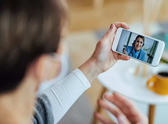 AnyConv.com__closeup-female-patient-using-smart-phone-having-video-chat-with-her-doctor